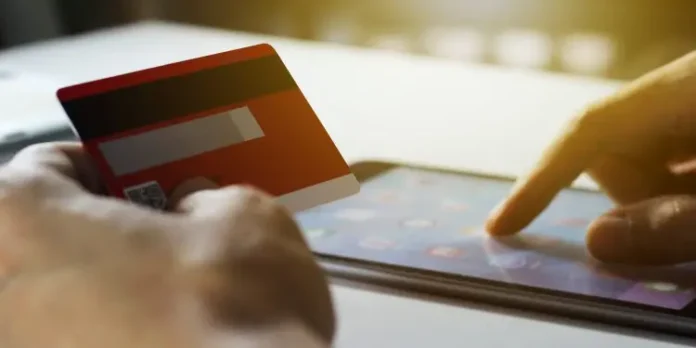 cropped-hand-person-holding-credit-card-while-using-mobile-phone-online-shopping-750x375-1