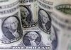Shares cautious, dollar slips as trade concerns persist