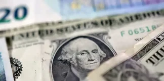 Dollar holds gains as attention turns to spending data for Fed clues