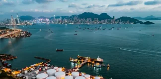 Oil prices fall to 4-year low below $55 as supply glut shows up